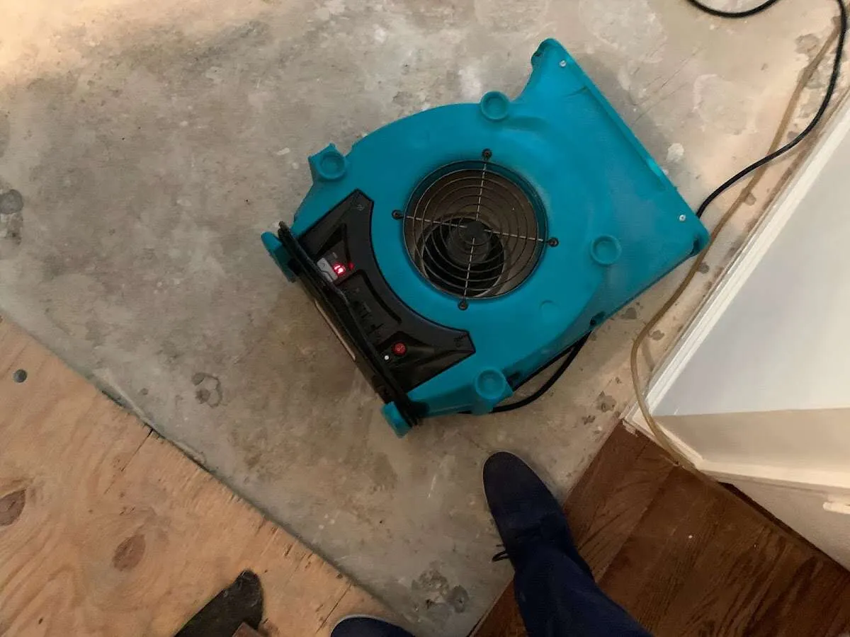 Air mover drying subfloor during Leak Detection & Repair in Harvard